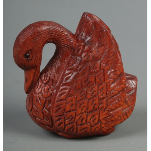 521 - A hand carved hardwood netsuke of a swan, signed to base.