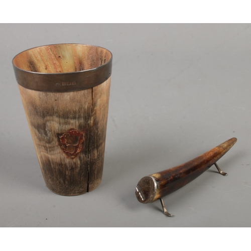 527 - A silver rimmed horn beaker along with a silver mounted horn knife rest.