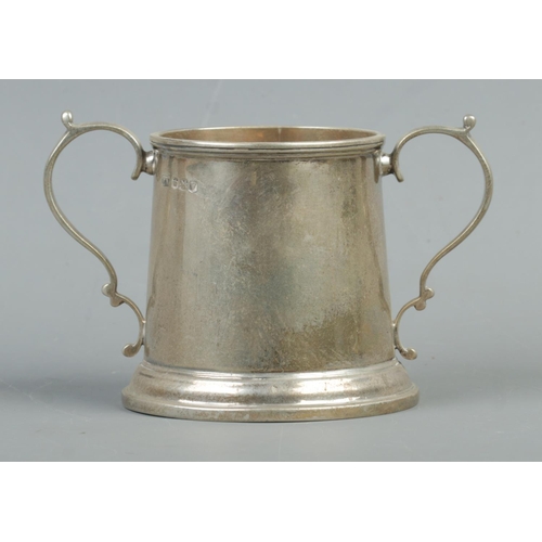 541 - A George VI twin handled silver cup, with circular stepped base. Assayed for Sheffield, 1938, by Emi... 