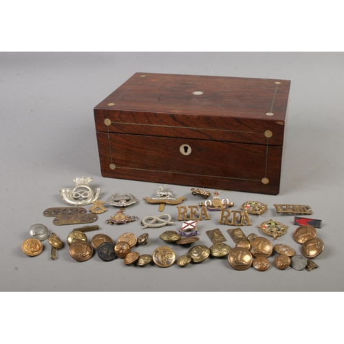 93 - A small collection of military cap badges and buttons to include Egypt East Lancashire, Marine and R... 