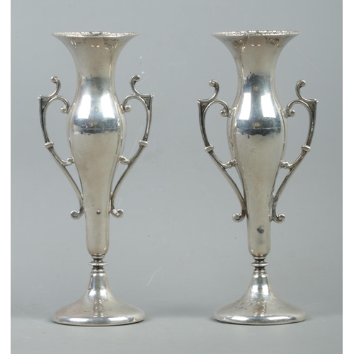 549 - A pair of Art Nouveau style twin handled weighted bud vases, with circular base. Assayed Birmingham,... 