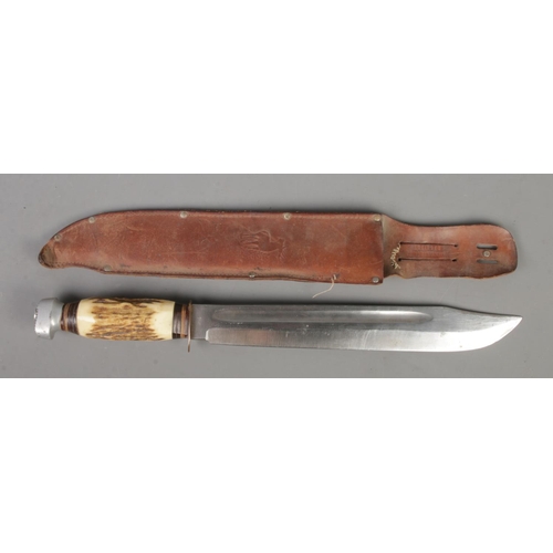 550 - A large Solingen bowie knife with associated leather sheath. Blade length 31cm. CANNOT POST OVERSEAS