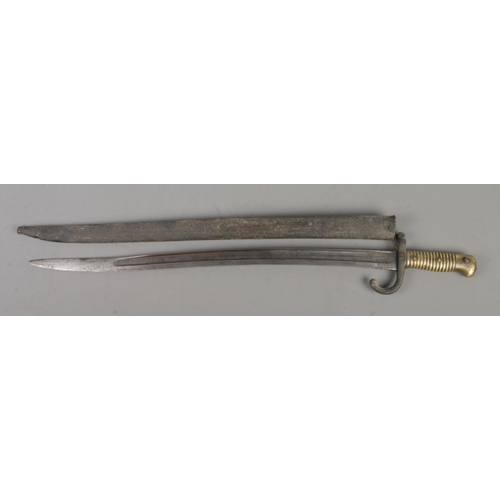 551 - A French M1866 bayonet with scabbard. Blade inscribed to edge and dated 1868. Blade length 57cm. CAN... 