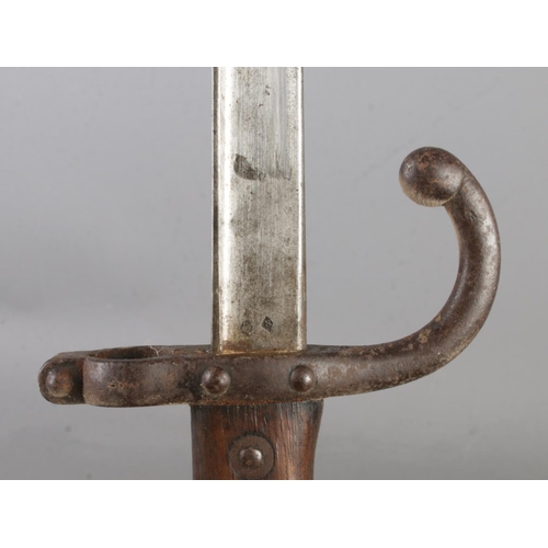 556 - A French 1874 bayonet with scabbard. Inscribed to edge of blade and dated 1878. Blade length 52cm. C... 