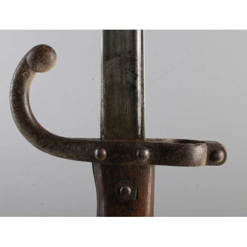 556 - A French 1874 bayonet with scabbard. Inscribed to edge of blade and dated 1878. Blade length 52cm. C... 