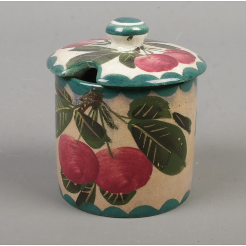 561 - A Weymss ware preserve pot and cover, decorated in cherries. Bearing marks 'T. Goode and Co' to the ... 