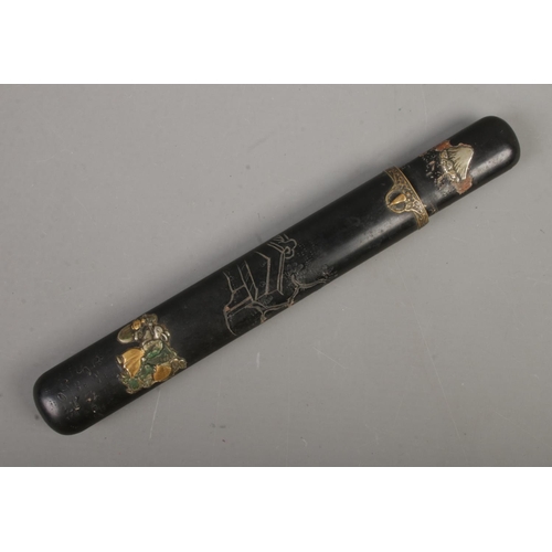 562 - A Japanese black lacquered Kiseru-zutsu (Pipe case) of flatted cylindrical form decorated with tradi... 