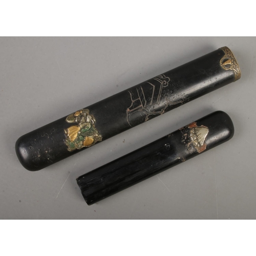 562 - A Japanese black lacquered Kiseru-zutsu (Pipe case) of flatted cylindrical form decorated with tradi... 