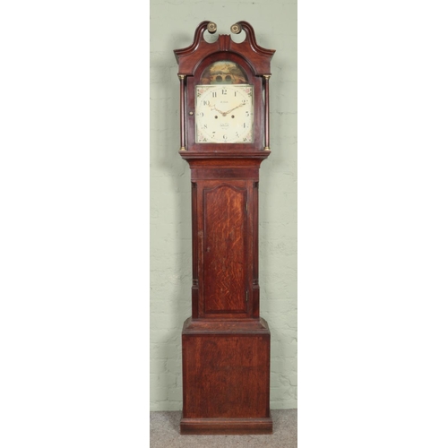 568 - A 19th century oak long case clock. Having twin swan neck pediment and painted dial marked for R. Ho... 