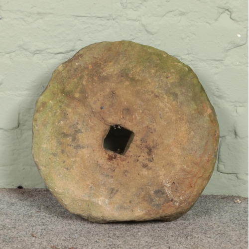 401 - A stone millstone. Diameter 39cm.