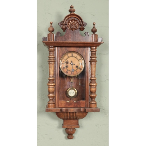 436 - A small walnut wall clock.