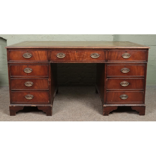 637 - A large mahogany pedestal writing desk with inset tooled leather top and Hepplewhite style oval plat... 