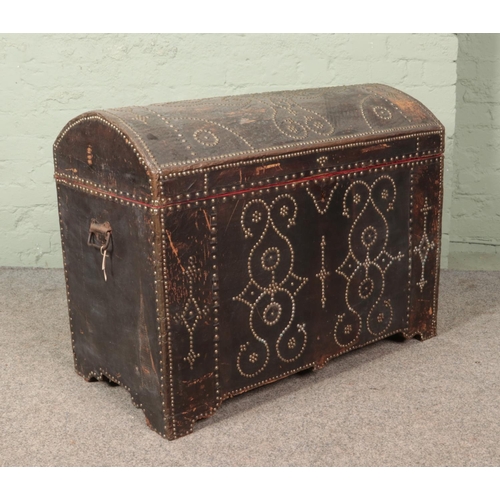 611 - An antique Eastern style trunk with studded decoration. 70cm x 90cm x 48cm.