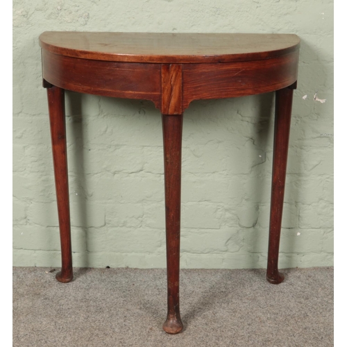 612 - A Georgian mahogany demi lune side table.