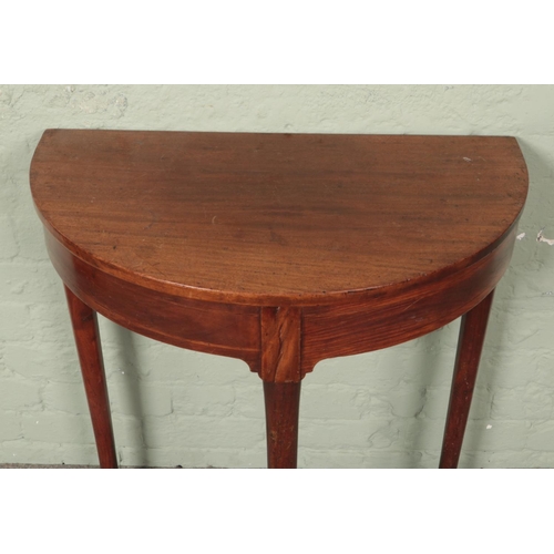 612 - A Georgian mahogany demi lune side table.