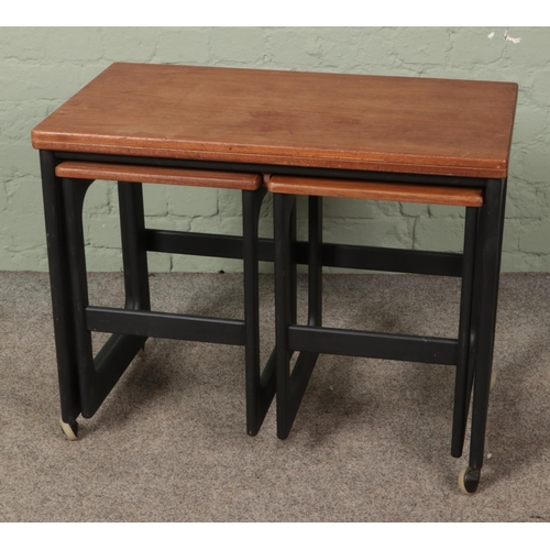 617 - A mid century fold over coffee table with two nesting tables underneath produced by Mckintosh of Kir... 