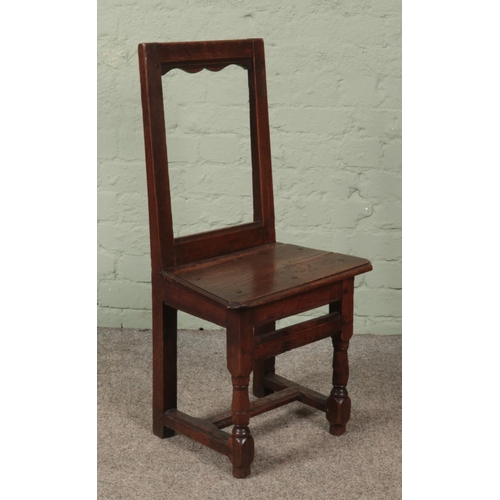 618 - A small late 18th/early 19th century oak chair of jointed construction. Height of back 88cm.