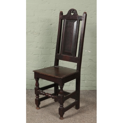 620 - A late 18th/early 19th century oak chair of jointed construction. Height of back 111cm.