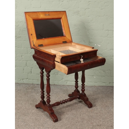 621 - An early 20th century mahogany work box with mirrored interior. Height 70cm.