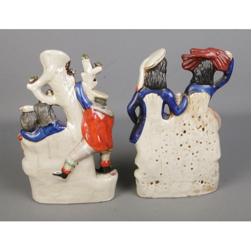 105 - Two Staffordshire flatback ceramic figures titled 'The Rival' spill vase and 'Highlander'.