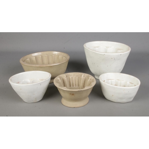 110 - Five stoneware jelly moulds of varying sizes to include example featuring floral motif.