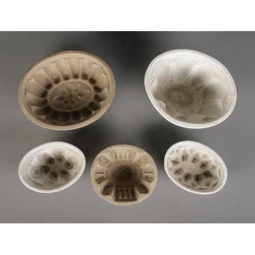 110 - Five stoneware jelly moulds of varying sizes to include example featuring floral motif.