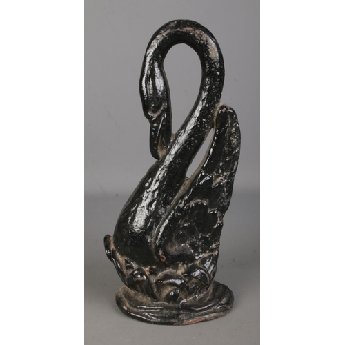 133 - A cast iron doorstop in the form of swan raised on plinth base. Approx. height 40cm.