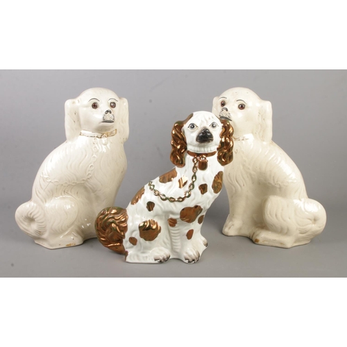 150 - A pair of Victorian mantel dogs along with one similar.