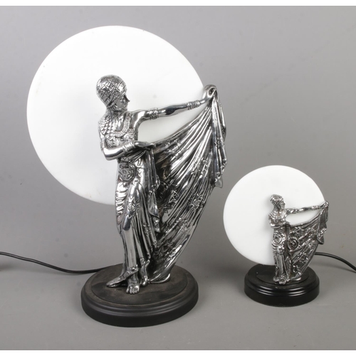 151 - Two white metal art deco style figural table lamps featuring dancers. Approx. height of tallest exam... 