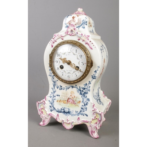 157 - A Longwy ceramic mantle clock featuring painted decoration depicting a young girl in a field of cows... 