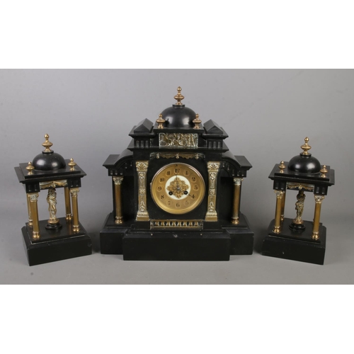 162 - An early 20th century black slate clock garniture with gilt metal column supports. Movement marked f... 