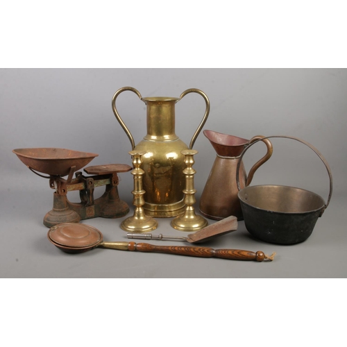 186 - A collection of metalwares. Includes candlesticks, scales, twin handled brass vessel, Victorian jam ... 