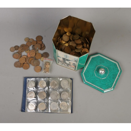 202 - A tin of pre-decimal British coins of mainly pennies and three-pence pieces along with a folder of r... 