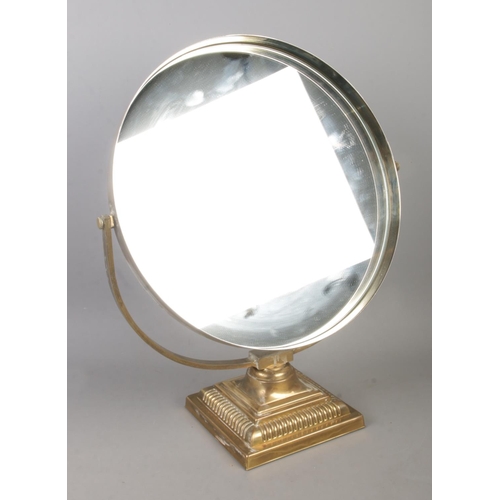 205 - A Durlston Design Ltd. circular mirror raised on square brass stepped Corinthian base.