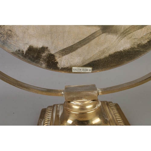 205 - A Durlston Design Ltd. circular mirror raised on square brass stepped Corinthian base.