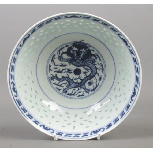 210 - A Chinese blue and white rice bowl. Decorated in underglaze blue with a dragon and bearing character... 