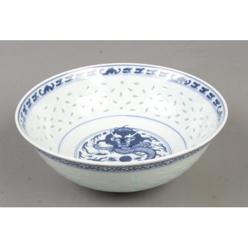 210 - A Chinese blue and white rice bowl. Decorated in underglaze blue with a dragon and bearing character... 