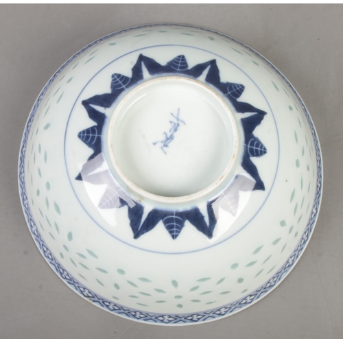 210 - A Chinese blue and white rice bowl. Decorated in underglaze blue with a dragon and bearing character... 