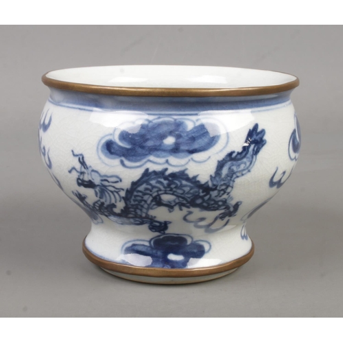 211 - A Chinese blue and white bowl. Decorated in underglaze blue with a dragon, having gilt metal mounts ... 