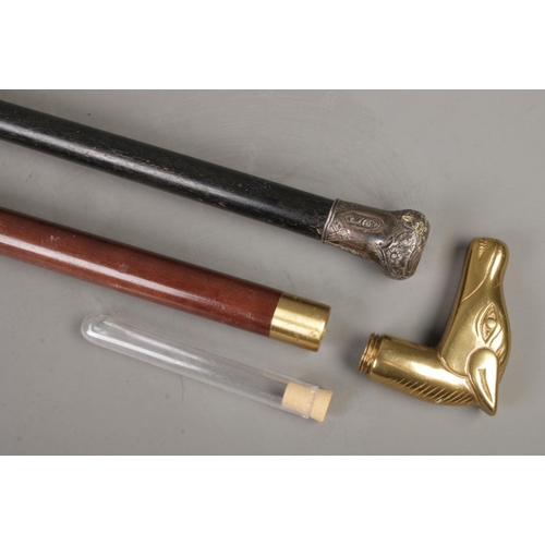 212 - Two walking canes to include drinking/tipple example with brass horse head pommel and one white meta... 