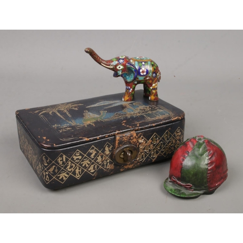 228 - A leather jewellery box with Swiss musical movement, along with a cloisonne elephant and a composite... 