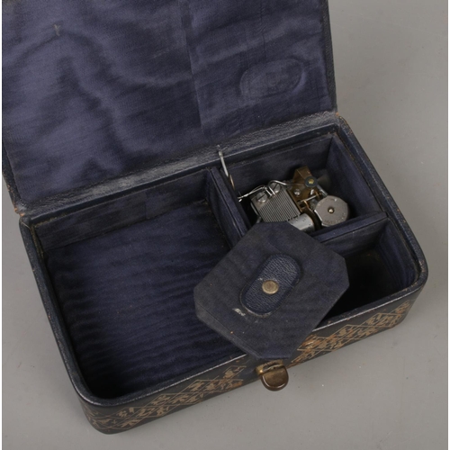 228 - A leather jewellery box with Swiss musical movement, along with a cloisonne elephant and a composite... 