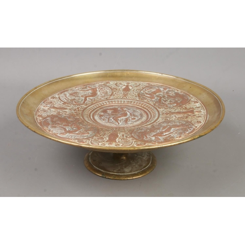 230 - A late 19th century brass and copper tazza. With central panel depicting Temperantia, surrounded by ... 