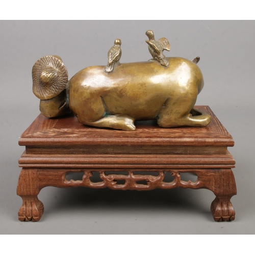 233 - A Chinese bronze sculpture formed as a seated man next to a recumbent water buffalo. Bearing charact... 