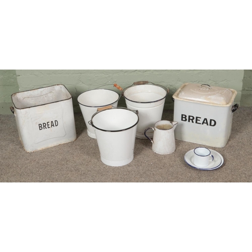 262 - A collection of enamel kitchen items including enamel bread bins, buckets, jug, mug and plates.