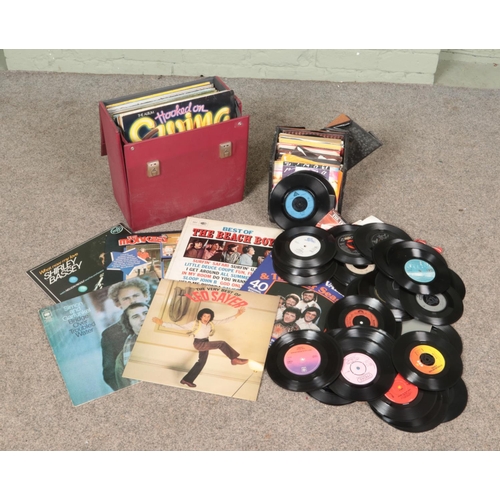 284 - A carry case and small box of records. Includes LP and single examples; The Monkees, The Beach Boys ... 