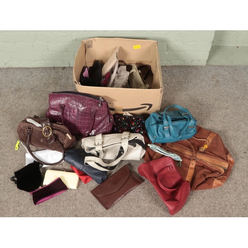 300 - A box of mostly ladies handbags. Includes leather examples, holdall, purses etc.