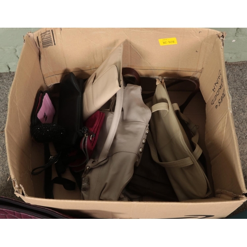 300 - A box of mostly ladies handbags. Includes leather examples, holdall, purses etc.