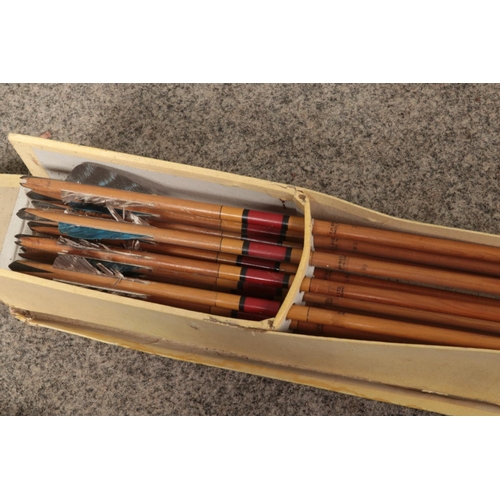 392 - A late 19th century to early 20th century yew wood bow along with a box of arrows both produced by F... 