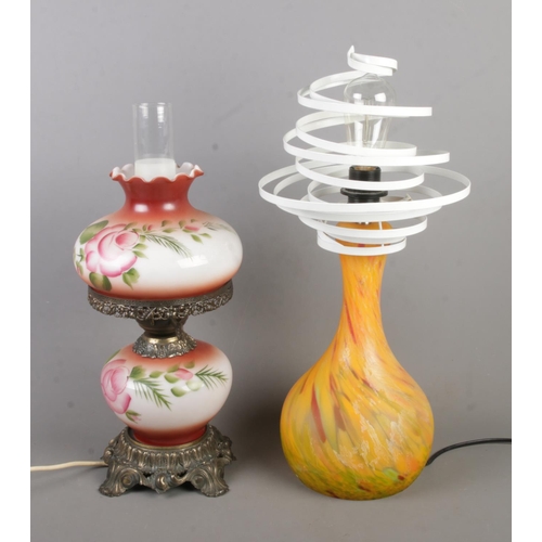 393 - Two lamps to include painted oil lamp converted to electric and art glass example.